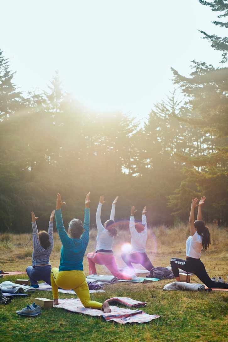 Women practicing yoga outdoors